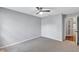 Carpeted bedroom with ceiling fan and view into the hallway at 2309 Mooney. Pl, Sun City Center, FL 33573