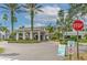 Clubhouse entrance with palm trees and manicured landscaping, creating a welcoming community atmosphere at 2309 Mooney. Pl, Sun City Center, FL 33573