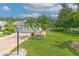 Well-maintained house with a two-car garage and lush landscaping at 2309 Mooney Pl, Sun City Center, FL 33573