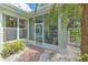 Enclosed front porch featuring a brick-paved walkway with a decorative front entrance at 2309 Mooney. Pl, Sun City Center, FL 33573