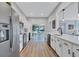 Open kitchen with stainless steel appliances, white cabinets, and an open view to the backyard at 2309 Mooney. Pl, Sun City Center, FL 33573