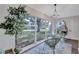 A sunroom with large windows, comfortable seating, plants, and ample natural light at 2309 Mooney. Pl, Sun City Center, FL 33573
