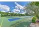 Outdoor pickleball and volleyball courts surrounded by lush landscaping and a clear blue sky at 2309 Mooney. Pl, Sun City Center, FL 33573