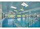 A spacious indoor pool area with plenty of natural light and accessibility features at 2309 Mooney. Pl, Sun City Center, FL 33573