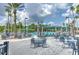 Inviting pool area with ample seating, umbrellas, and lush tropical landscaping at 2309 Mooney. Pl, Sun City Center, FL 33573