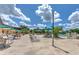 Expansive community pool area with ample seating, umbrellas, and lush landscaping under a sunny sky at 2309 Mooney. Pl, Sun City Center, FL 33573