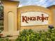 Kings Point community entrance sign surrounded by lush landscaping with a decorative tile background at 2309 Mooney. Pl, Sun City Center, FL 33573