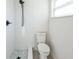 Bathroom featuring a tiled walk-in shower with black hardware and mosaic tile flooring, plus a white toilet at 3396 Minnow Creek Dr, Hernando Beach, FL 34607