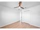 The bedroom boasts a ceiling fan, neutral walls, baseboards, and light wood floors at 3396 Minnow Creek Dr, Hernando Beach, FL 34607