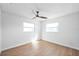 This bedroom has a ceiling fan, neutral walls, baseboards and light-colored wood floor at 3396 Minnow Creek Dr, Hernando Beach, FL 34607