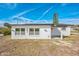 Charming single-story home with fresh white paint, seahorse adornments, and neatly kept landscaping at 3396 Minnow Creek Dr, Hernando Beach, FL 34607