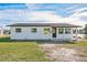 Charming single-story home with a freshly painted exterior and well-maintained lawn under a partly cloudy sky at 3396 Minnow Creek Dr, Hernando Beach, FL 34607