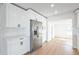 Modern kitchen featuring white cabinets, stainless steel appliances, quartz countertops, and hardwood floors at 3396 Minnow Creek Dr, Hernando Beach, FL 34607