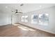 Bright living room featuring hardwood floors, recessed lighting, and three large windows, offering natural light and serene water views at 3396 Minnow Creek Dr, Hernando Beach, FL 34607