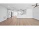 Spacious room with light-colored wood floor, new fixtures and view of the open kitchen at 3396 Minnow Creek Dr, Hernando Beach, FL 34607