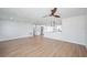 Spacious living room with light wood floors open to a modern kitchen with stainless steel appliances at 3396 Minnow Creek Dr, Hernando Beach, FL 34607