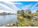 Scenic view of a waterfront canal with houses, trees, boats, and a bright blue sky at 3396 Minnow Creek Dr, Hernando Beach, FL 34607