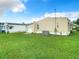 A level backyard features a storage shed, central AC unit and manicured green grass, excellent for outdoor enjoyment at 35801 Verda Dr, Zephyrhills, FL 33541