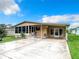 Charming single-story home featuring a cozy porch, lush green lawn, and long drive way perfect for outdoor Florida living at 35801 Verda Dr, Zephyrhills, FL 33541