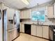 Well-lit kitchen featuring stainless steel refrigerator and modern appliances at 35801 Verda Dr, Zephyrhills, FL 33541