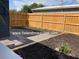 Fenced backyard with mulched garden and stone pathway at 3763 Dartmouth N Ave, St Petersburg, FL 33713
