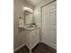 Bathroom with a granite countertop vanity, stylish mirror and fixtures, and storage cabinet at 3763 Dartmouth N Ave, St Petersburg, FL 33713