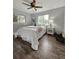 This bedroom features wood-look floors and natural light from the two windows at 3763 Dartmouth N Ave, St Petersburg, FL 33713