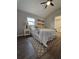 Cozy bedroom boasts wood-look floors, light grey walls, and a doorway to the bathroom at 3763 Dartmouth N Ave, St Petersburg, FL 33713