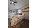 Comfortable bedroom with wood-look floors, light gray walls, and unique wall decor at 3763 Dartmouth N Ave, St Petersburg, FL 33713