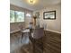 Dining area featuring hardwood floors, a glass table, and a view of the front entrance at 3763 Dartmouth N Ave, St Petersburg, FL 33713