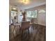 Bright dining area features hardwood floors, glass table, and natural light through the window at 3763 Dartmouth N Ave, St Petersburg, FL 33713