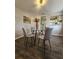 Dining area features hardwood floors, a glass table, and views of the kitchen at 3763 Dartmouth N Ave, St Petersburg, FL 33713