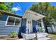 Inviting front porch with cozy seating and fresh landscaping, painted a pleasant blue hue at 3763 Dartmouth N Ave, St Petersburg, FL 33713