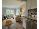 Living and kitchen view featuring stainless dishwasher, laminate floors, and open floorplan at 3763 Dartmouth N Ave, St Petersburg, FL 33713