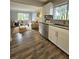 Open-concept living and kitchen area with wood laminate floors, stainless appliances, and a bright living space at 3763 Dartmouth N Ave, St Petersburg, FL 33713