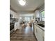 Open kitchen to living space featuring stainless appliances, laminate floors, and light-filled living space at 3763 Dartmouth N Ave, St Petersburg, FL 33713