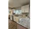 Updated kitchen with granite countertops, stainless steel dishwasher, and white cabinets at 3763 Dartmouth N Ave, St Petersburg, FL 33713