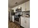 Kitchen with stainless steel appliances, white cabinetry, and granite countertops at 3763 Dartmouth N Ave, St Petersburg, FL 33713