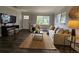 Inviting living room with neutral furnishings, dark wood floors, and natural light from large windows at 3763 Dartmouth N Ave, St Petersburg, FL 33713