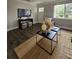 Well-lit living room with dark wood floors, modern TV, and stylish furnishings at 3763 Dartmouth N Ave, St Petersburg, FL 33713