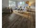 Cozy living room with dark laminate flooring, a jute rug, and comfortable modern furniture at 3763 Dartmouth N Ave, St Petersburg, FL 33713