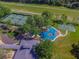 Aerial view of community playground, tennis courts, basketball court, walking path, and lush landscaping at 6527 Stonington Dr, Tampa, FL 33647
