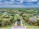 An aerial view showcases a residential area with tree-lined streets, landscaped medians, and a central fountain at 6527 Stonington Dr, Tampa, FL 33647