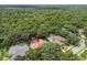 Aerial view of a home nestled among lush trees with a private pool and screened enclosure at 6527 Stonington Dr, Tampa, FL 33647