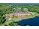 Stunning aerial view of a large waterfront estate with golf course, driving range, pool, and luxurious amenities at 6527 Stonington Dr, Tampa, FL 33647