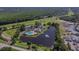 Community aerial showcasing a pool, clubhouse, pond with fountain, tennis courts, and lush landscaping at 6527 Stonington Dr, Tampa, FL 33647