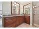 Elegant bathroom with dual sinks, granite countertops, and a glass-enclosed shower at 6527 Stonington Dr, Tampa, FL 33647
