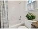 Bright bathroom featuring a white tiled shower and tub, and a granite topped vanity at 6527 Stonington Dr, Tampa, FL 33647