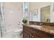 Bathroom with a granite vanity, shower/tub combo, and window at 6527 Stonington Dr, Tampa, FL 33647