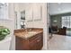 Bathroom vanity with granite countertop and ample lighting at 6527 Stonington Dr, Tampa, FL 33647
